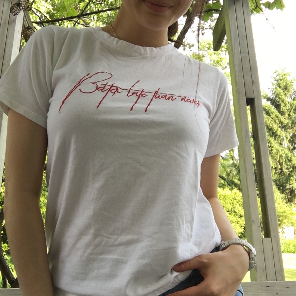 White tee with red text embroidery